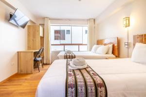 Letto o letti in una camera di Hotel Cusco Guest Home