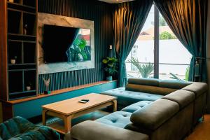 a living room with a couch and a table at Condos De La ChiChi in Kumasi