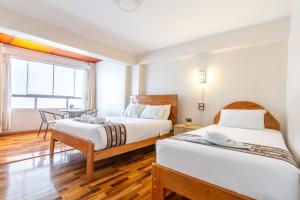 Letto o letti in una camera di Hotel Cusco Guest Home