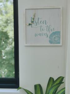 a picture of a sign to the waves on a wall at Our Paradise - Jaco Apartment in Jacó +41 photos
