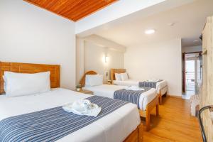 Letto o letti in una camera di Hotel Cusco Guest Home