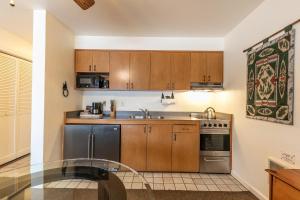 a kitchen with wooden cabinets and a sink and a stove at 145 Bldg C condo in Truckee +14 photos