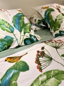 two beds with leaves and a bird on them at Belvedere Azur Loft in Grimaud +42 photos