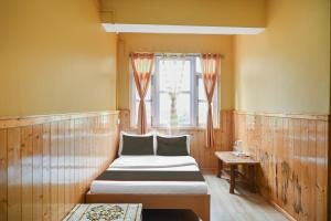 Hotel O Kaizen Residency客房内的一张或多张床位