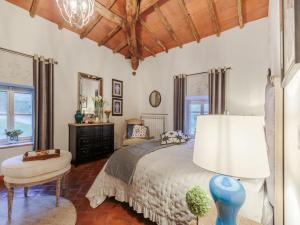 a bedroom with a bed and a table and a lamp at Villa in Lucca with Private Pool in San Macario In Piano +63 photos