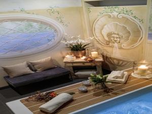 a living room with a tub and a table with candles at Apartment in Lucca near Guinigi Tower in Lucca