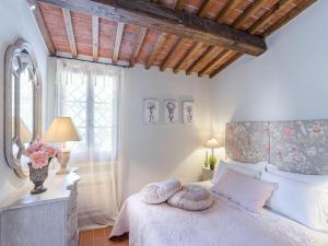 a bedroom with a bed with two pillows on it at Cottage in Tuscany near Lucca and Pistoia in Uzzano