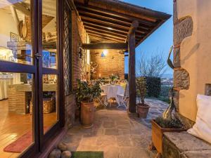 a patio with a table and a dining room at Cottage in Tuscany near Lucca and Pistoia in Uzzano