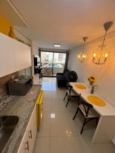 a kitchen with a table and chairs in a room at Flat a 50m da beira-mar do Cabo Branco - Gold Flat 121 in João Pessoa