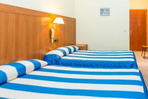 Postel nebo postele na pokoji v ubytování Pensión Coral