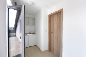 un baño con una puerta que conduce a una cocina en Hotel New In Guesthouse, en Ingolstadt