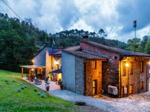 a brick house with lights on the side of it at Villa in Lucca with Private Pool in San Macario In Piano