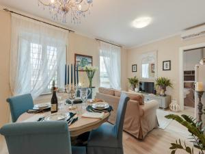 a living room with a table and a couch at Villa outside historic walls of Lucca in Lucca