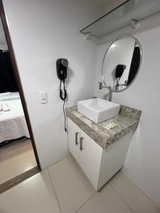 a bathroom with a sink and a mirror at Flat a 50m da beira-mar do Cabo Branco - Gold Flat 121 in João Pessoa