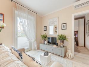 a living room with a couch and a tv at Villa outside historic walls of Lucca in Lucca