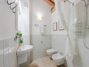 a white bathroom with a toilet and a sink at Villa in Tuscany with Stunning Valley Views in San Gennaro +39 photos