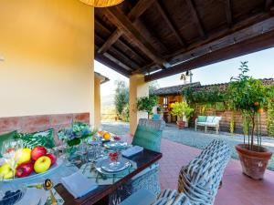 an outdoor dining room with a table and chairs with fruit on it at Villa in Tuscany near Lucca with Pool in Lucca