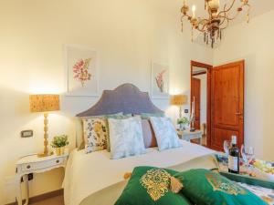 a bedroom with a bed and a chandelier at Villa in Tuscany near Lucca with Pool in Lucca