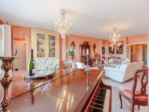 a living room with a table and a piano at Apartment in Lucca near Historic Center in Lucca +58 photos
