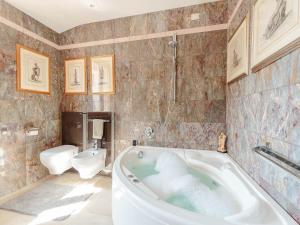 a bathroom with a tub and a toilet at Apartment in Lucca near Historic Center in Lucca