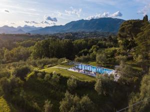 an aerial view of a villa with a swimming pool and mountains at 10 Bedrooms Villa in Lucca with pool in Montecarlo