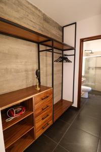 a bathroom with a wooden cabinet and a mirror at Palmas Luxury Apartment 106 in Oaxaca City +43 photos