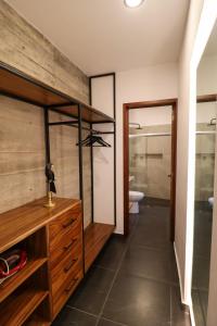 a bathroom with a wooden dresser and a toilet at Palmas Luxury Apartment 106 in Oaxaca City