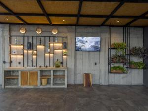 a room with a counter and a tv on a wall at Palmas Luxury Apartment 106 in Oaxaca City
