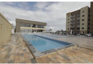 a large swimming pool in front of a building at Belíssimo Apto a 2 km da Litorânea in São Luís