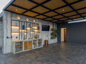 a lobby with a large stone wall with lights on it at Palmas Luxury Apartment 103 in Oaxaca City