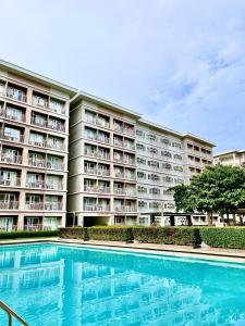 a large apartment building with a large swimming pool at Khyzer's Place in Quezon City +20 photos
