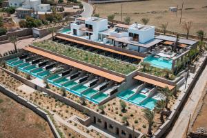 an aerial view of a house with a pool at Noir Mykonos in Mikonos +124 photos