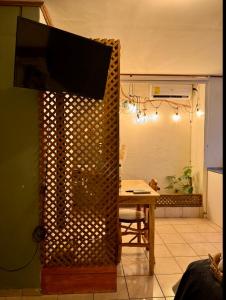 a living room with a television on top of a wall at Cafeto Loft Lovely and private loft in Ruta de las Flores heart in Juayúa