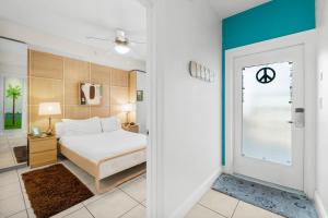 a bedroom with a bed and a door leading to a bathroom at 30A - Cassine Station by Panhandle Getaways in Santa Rosa Beach +23 photos