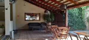 a patio with wooden tables and chairs and a mirror at Flat Acqua Ville in Caldas Novas