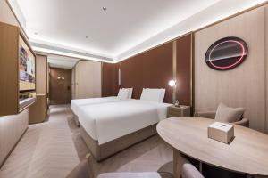 Voodi või voodid majutusasutuse Tianjin Station Crystal Orange Hotel toas