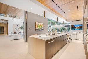 a kitchen with a sink and a living room at Hutton Villa in Los Angeles