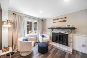 a living room with two chairs and a fireplace at Family Yarmouth Beach Resort 3BR Getaway in Yarmouth