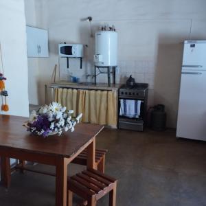 a kitchen with a table with flowers on it at Sol de Maimará in Maimará