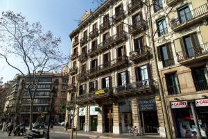 a tall building on a city street with people standing outside at Center Gran Via in Barcelona