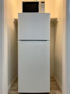 a white refrigerator with a microwave on top of it at Beachgate Condo Suites and Hotel 512AB condo in Port Aransas