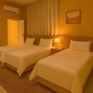 Postel nebo postele na pokoji v ubytování Remal Inn