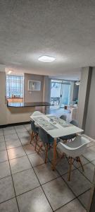 a living room with a table and chairs and a kitchen at LaMouette 8 Manaba Beach Uvongo in Margate