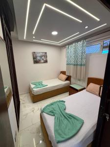 a small room with two beds and a room with at porto marina resort challet in El Alamein