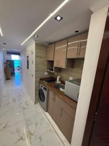 a kitchen with a sink and a washing machine at porto marina resort challet in El Alamein
