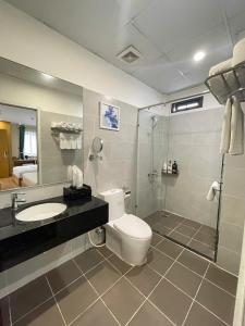 a bathroom with a toilet and a sink and a shower at A25 Hotel - 142 Bùi Thị Xuân in Ho Chi Minh City
