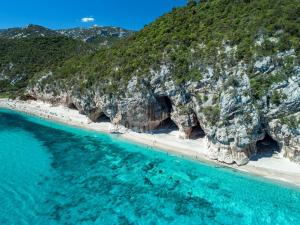 an aerial view of a beach with blue water at BenitiKe House in Cala Gonone