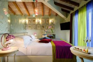 
a bedroom with a large bed and a large window at Ville Sull'Arno in Florence
