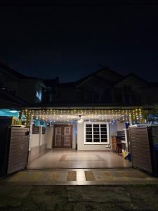a house with a lot of lights on it at night at HomeS7 Shah Alam in Shah Alam