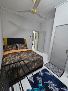 a bedroom with a bed and a ceiling fan at HomeS7 Shah Alam in Shah Alam